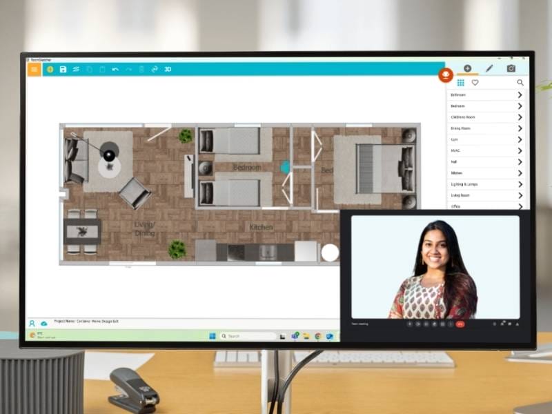 Desktop monitor displaying a 2D floor plan in the RoomSketcher app, showing a layout with three bedrooms, a kitchen, and a combined living/dining area. A sidebar on the right lists furniture categories. In the bottom-right corner of the screen, a video call window shows a smiling woman in a patterned top, suggesting remote collaboration or design consultation.