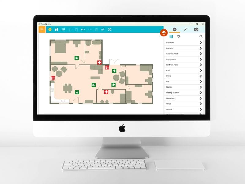 iMac screen displaying the RoomSketcher app with a floor plan layout that includes emergency exit and first aid symbols.