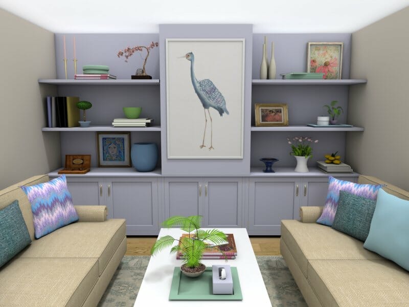 3D-rendered image of a cozy living room with a symmetrical layout. Two beige sofas with colorful throw pillows face a white coffee table, which is topped with books, a plant, and decor. The back wall features built-in lavender-colored shelving and cabinets, styled with vases, books, artwork, and a large central framed print of a blue heron.