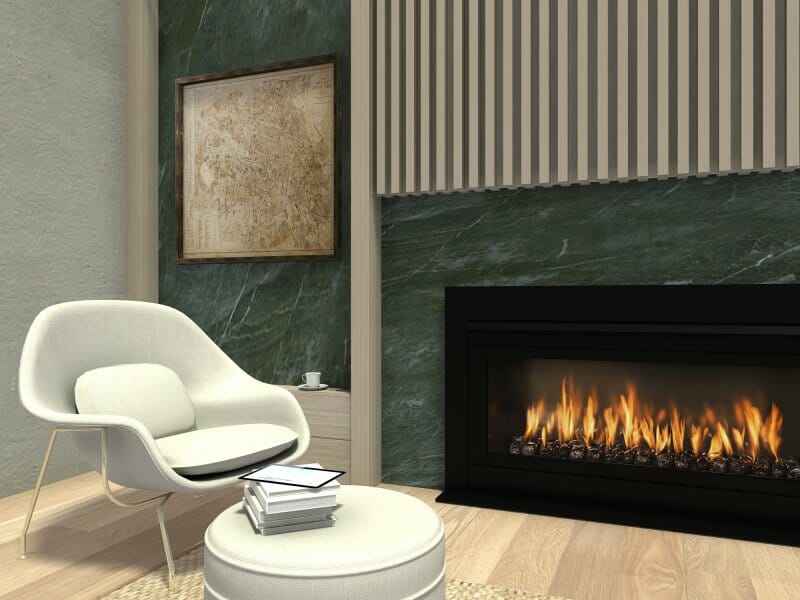Cozy reading nook featuring a modern white lounge chair and ottoman beside a sleek black fireplace with a lively flame. The space includes a small side table with a cup, a stack of books on the ottoman, green marble accent walls, a neutral-toned wood slat panel, and a framed artwork above the table. Warm lighting and natural textures create a calm, inviting atmosphere.